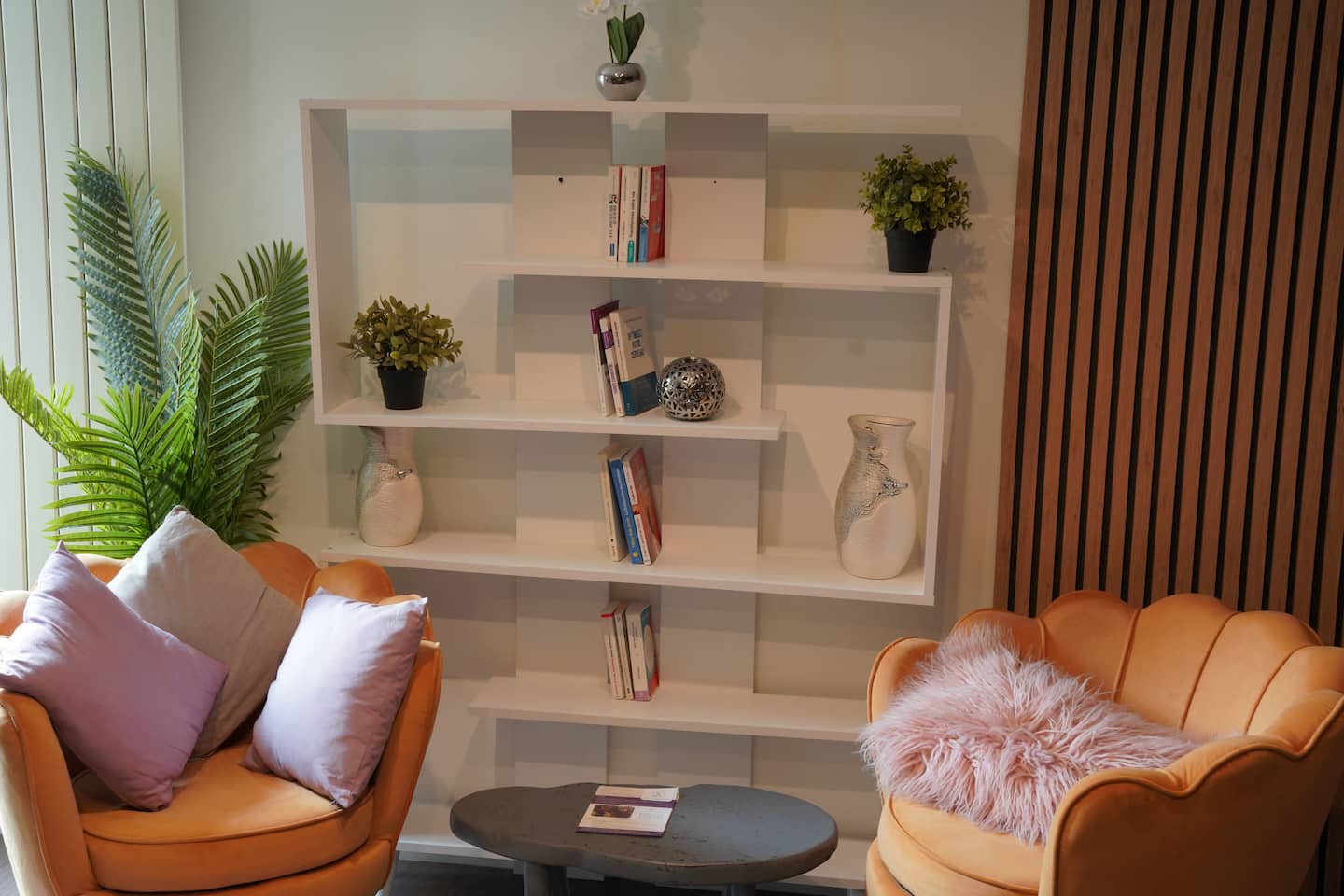 Le coin salon : deux fauteuils, plantes et étagère décorative